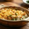 A delicious Chicken Green Bean Casserole served in a rustic dish with a fork, highlighting its creamy texture and crispy topping.