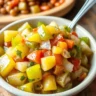 Bowl of Chow Chow relish made from green tomatoes, cabbage, and peppers, served with sides like beans and cornbread.