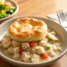 Crockpot Chicken Pot Pie with golden-brown biscuits and creamy filling served warm.