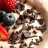 Delicious Protein Pudding Recipe, topped with fresh berries and chocolate.