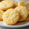 Lemon shortbread recipe: A plate of lemon shortbread cookies with lemon slices and zest, a perfect treat for any occasion.