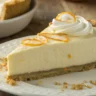 Orange Creamsicle Pie with whipped cream, fresh orange zest, and orange slices on a rustic table.