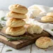 Stack of golden-brown keto cloud bread rounds on wooden board showing light and fluffy texture perfect for low-carb diet